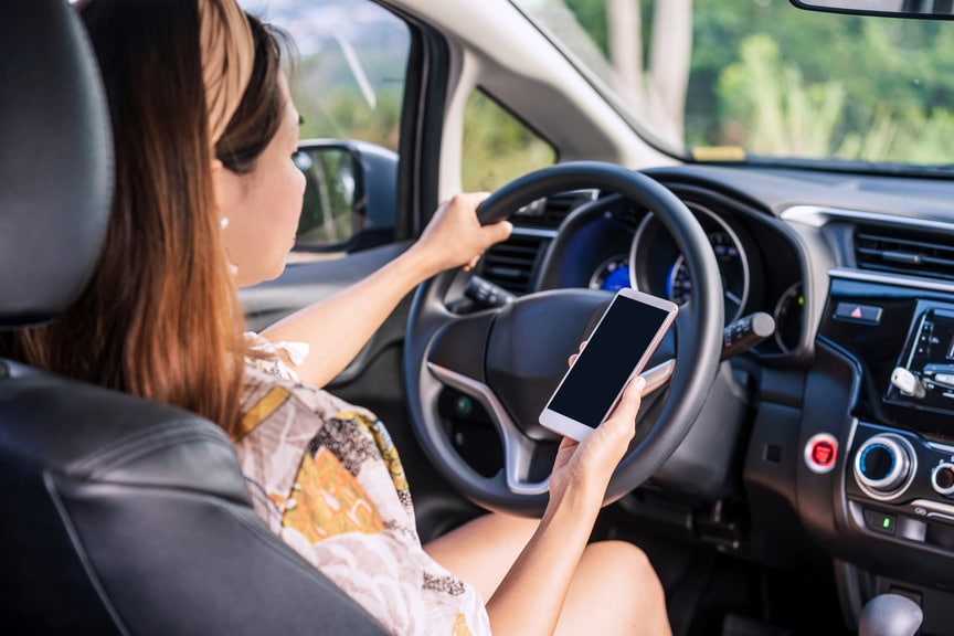 Woman Using Her Phone While Driving | Motor Vehicle Accident Lawyers | Gash & Associates, P.C.