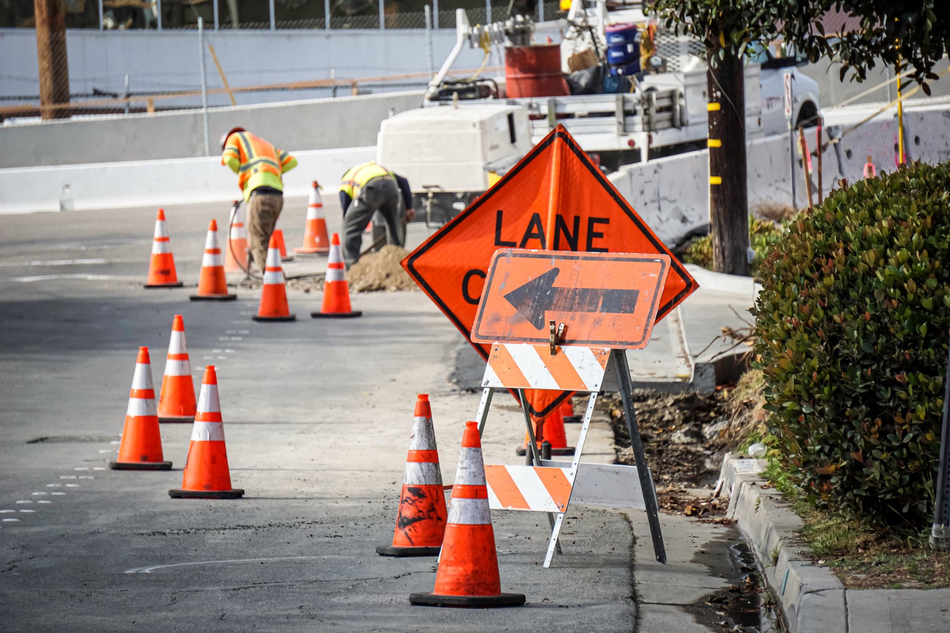 Road construction work with orange cones and signs