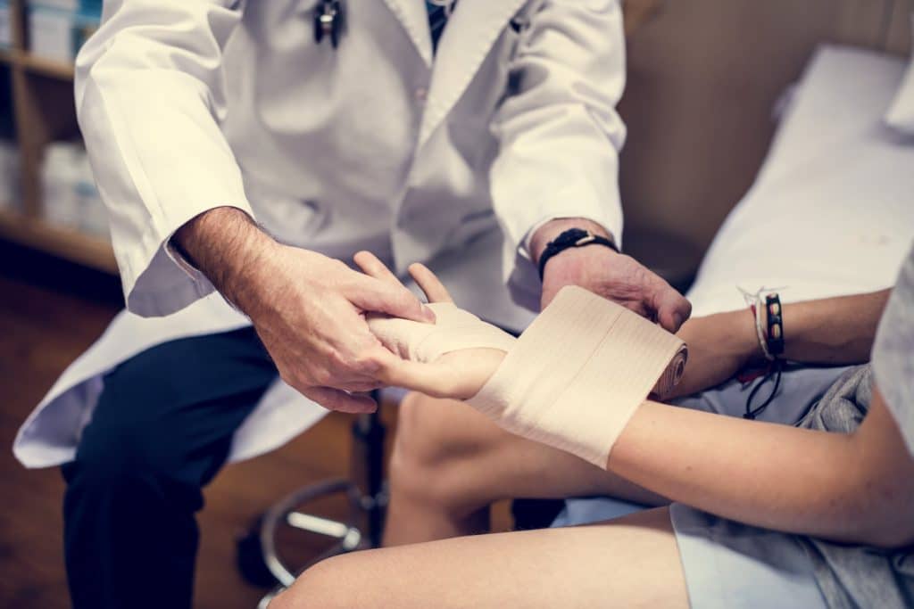 Doctor Assisting An Injured Patient | Workplace Injury Lawyers in NYC | Gash & Associates, P.C.