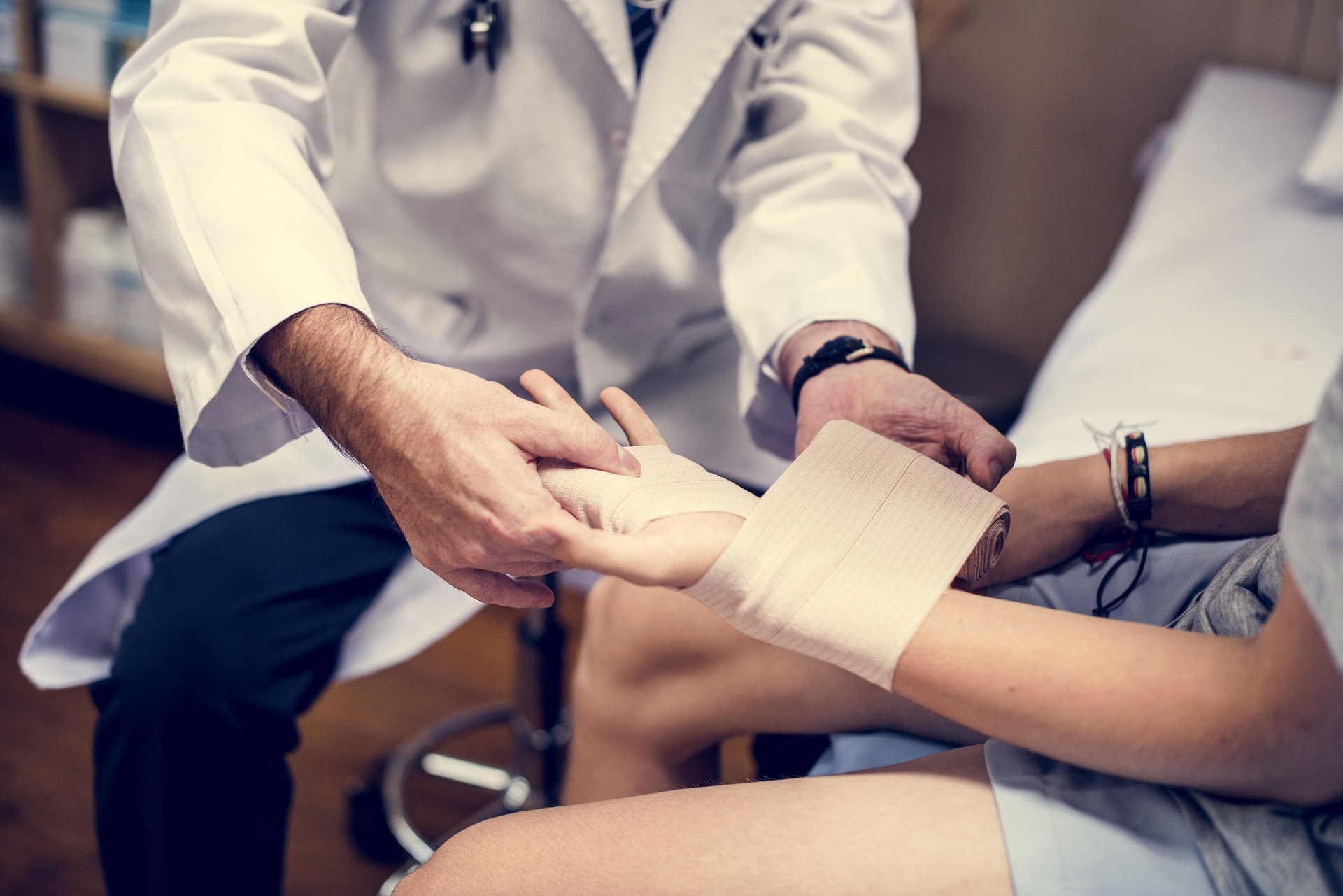 Doctor treats a worker's hand injury | workplace accidents lawyer | Gash & Associates, P.C.