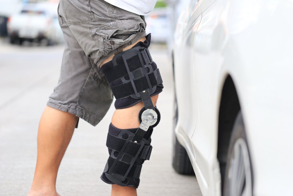 Person in grey shorts wearing a knee support