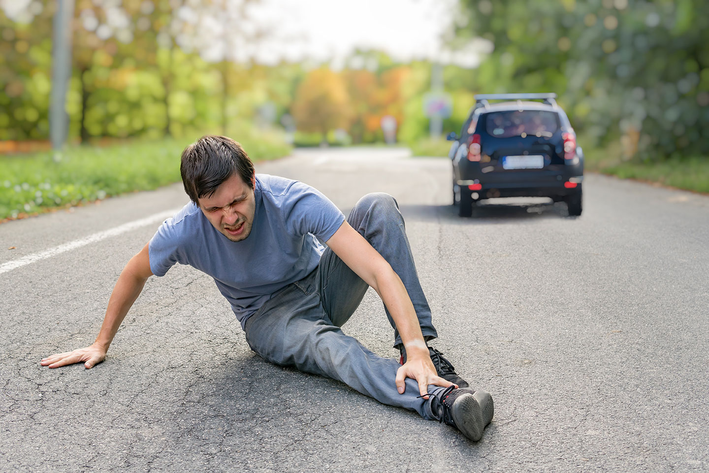 Injured Man Has Broken Leg Sitting on Road | Motor Vehicle Accident Lawyer | Gash & Associates, P.C.