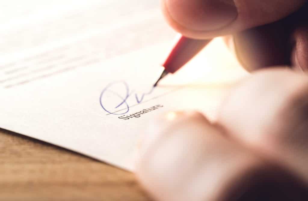 A Man Signing A Document | Personal Injury Lawyers in New York City | Gash & Associates, P.C.