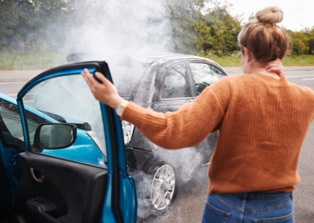 Woman Getting Out Of Car After Crash | Motor Vehicle Accident Lawyers | Gash & Associates, P.C