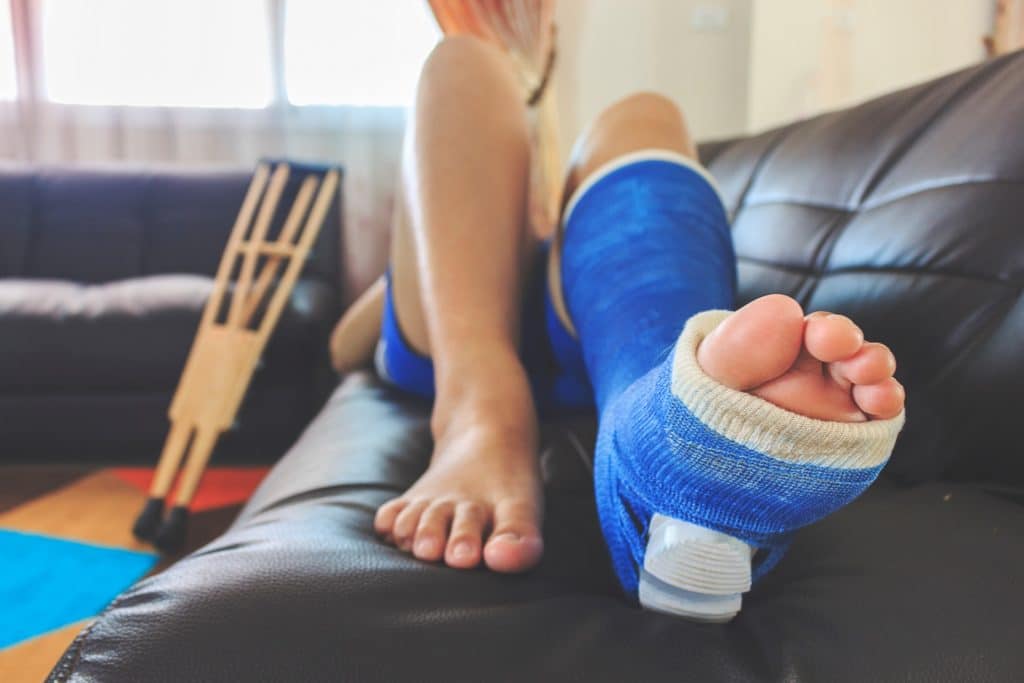 Injured Man With Plaster Lying On Sofa | Personal Injury Law Firm in NYC | Gash & Associates, P.C.