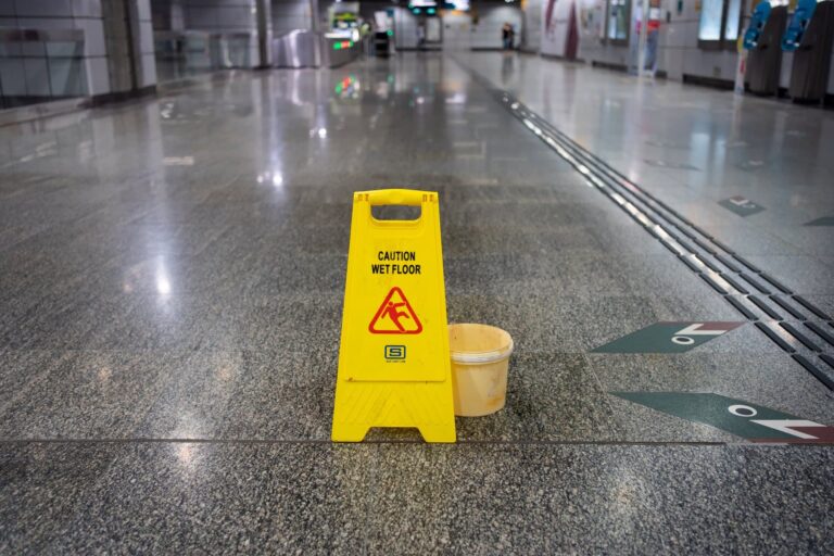 Yellow 'Caution Wet Floor' sign | slip and fall accidents lawyer | Gash & Associates, P.C.