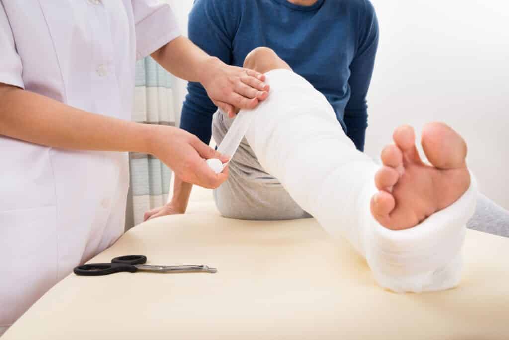 Doctor Bandaging Patient's Leg | Personal Injury Law Firm in NYC | Gash & Associates, P.C.