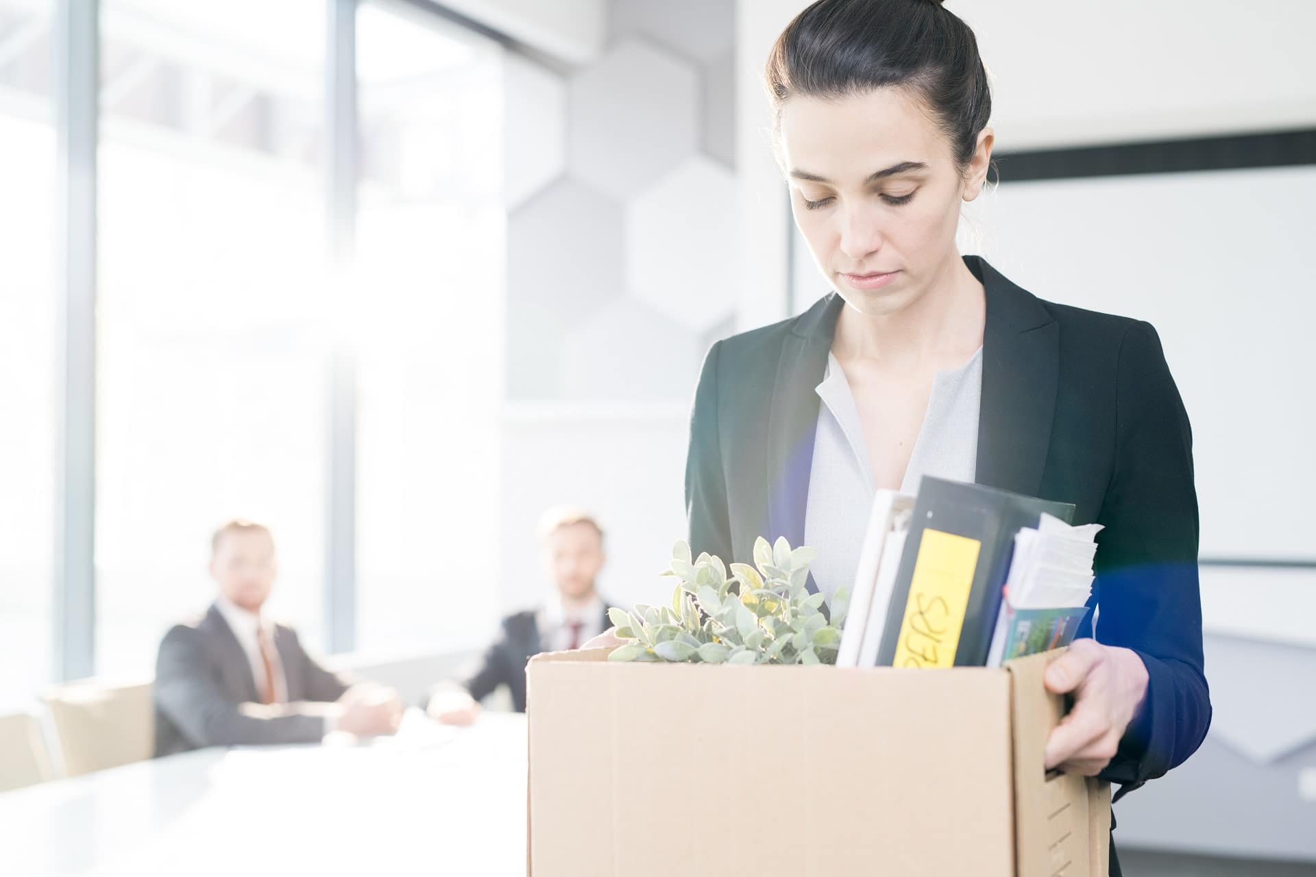 Woman Holding A Box Leaving Office | Employment Discrimination Lawyers | Gash & Associates, P.C.