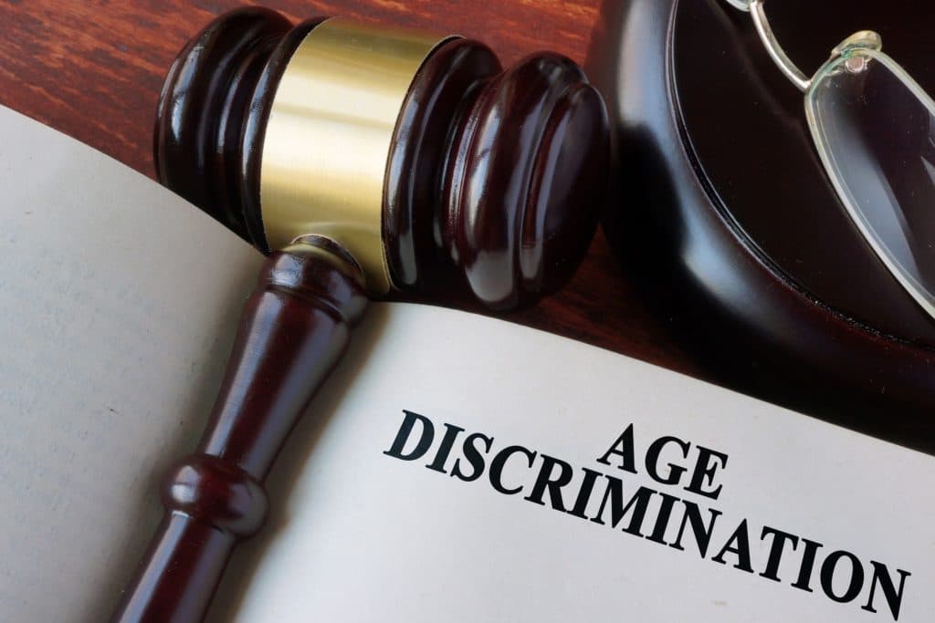 Gavel laying on open book page entitled Age Discrimination