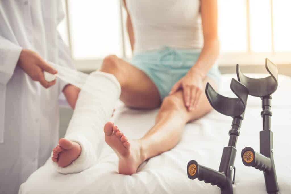 Doctor Casting Injured Woman's Leg | Premises Liability Attorneys in NYC | Gash & Associates, P.C.