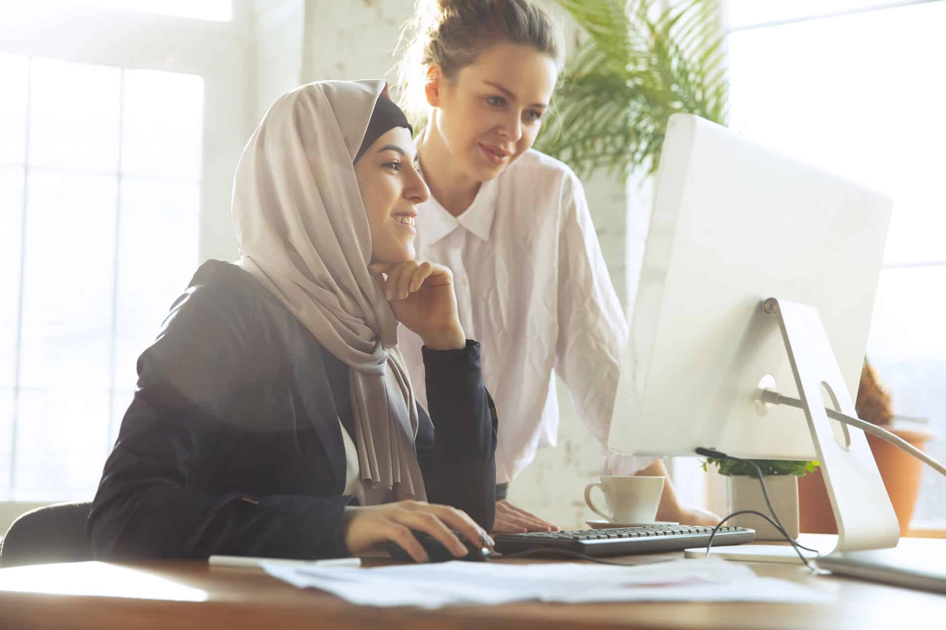 Interfaith colleagues collaborate at work | employment discrimination ny | Gash & Associates, P.C.