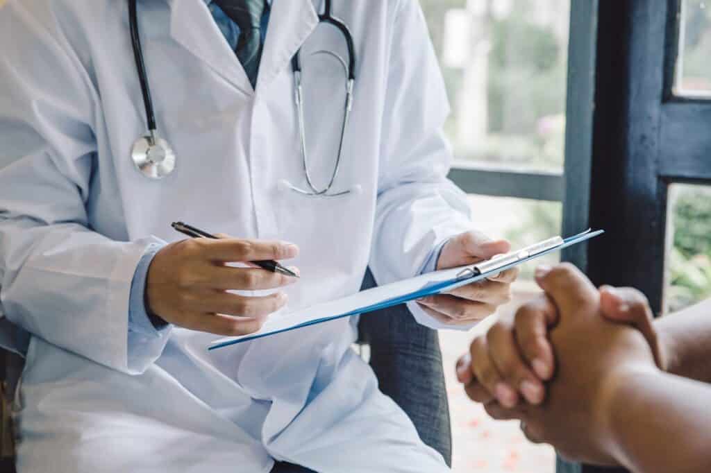 Doctor Giving Prescription To A Woman | Medical Negligence Lawyers in NYC | Gash & Associates, P.C.