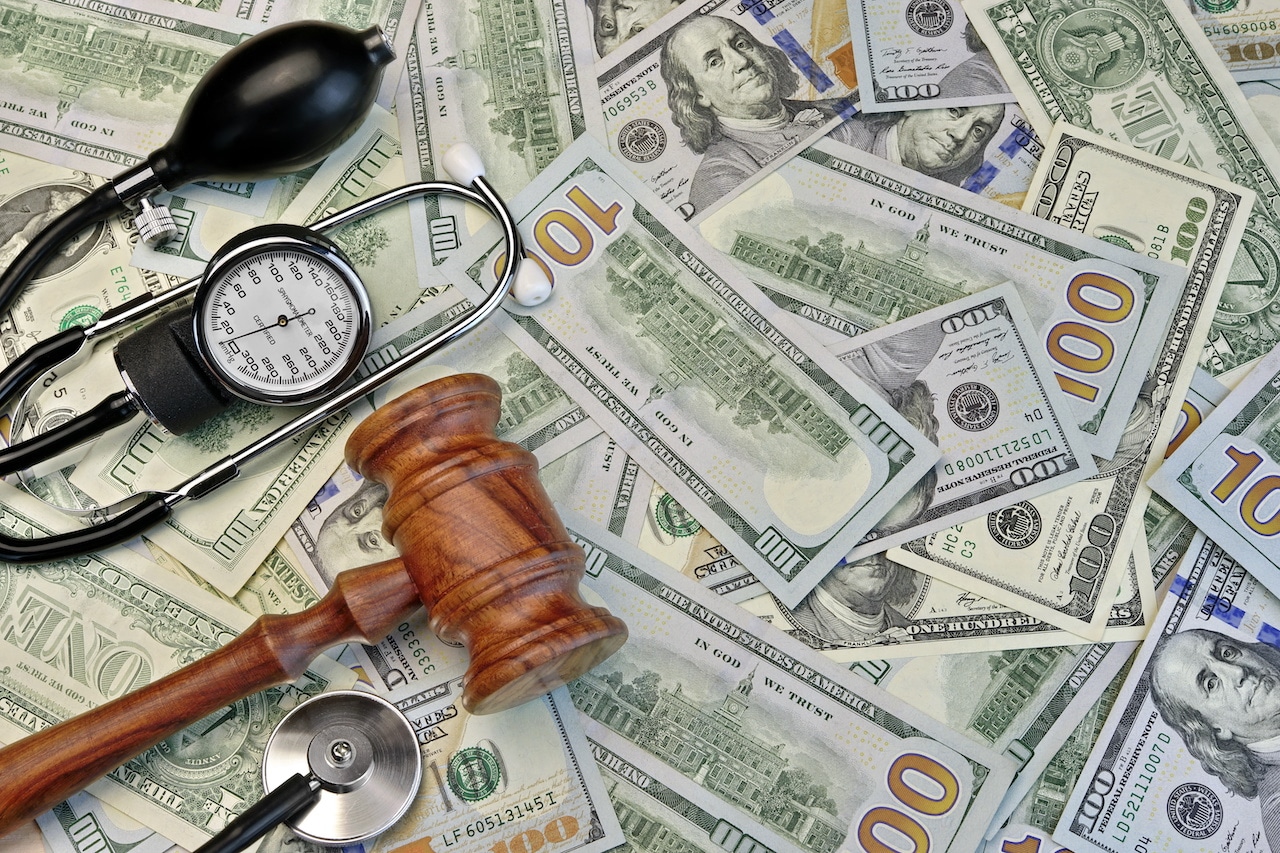 Judges Gavel And Medical Tools On Dollar Cash Background