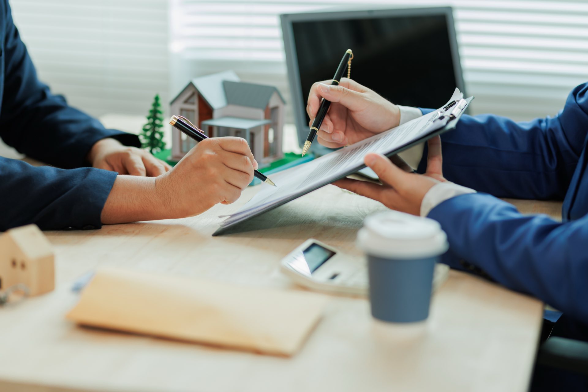 Person holding clipboard and pen showing to another person who is writing something on the clipboard