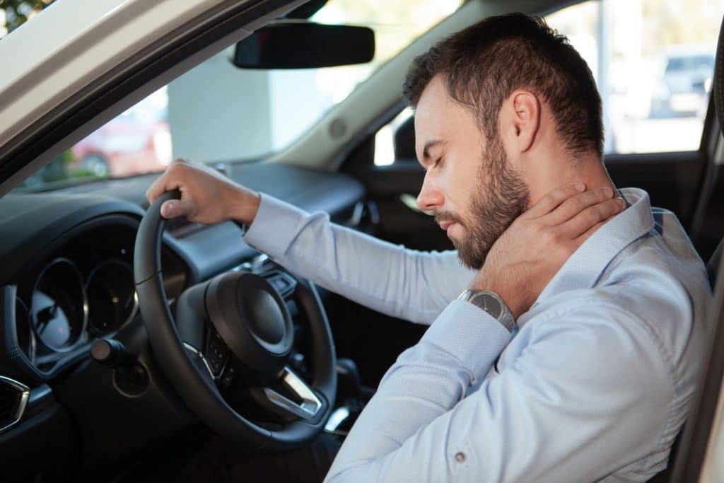 Male Driver Having Neck Pain Sitting In Car | Motor Accident Lawyers in NYC | Gash & Associates, P.C