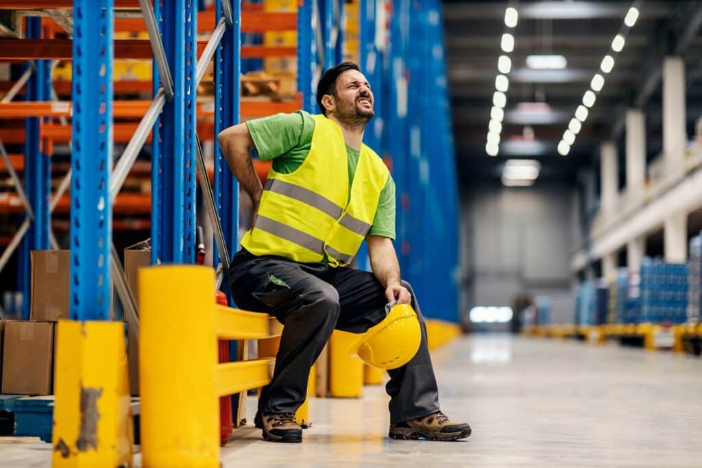 A Warehouse Worker Having Back Pain At Work | Workplace Injury Lawyers | Gash & Associates, P.C.