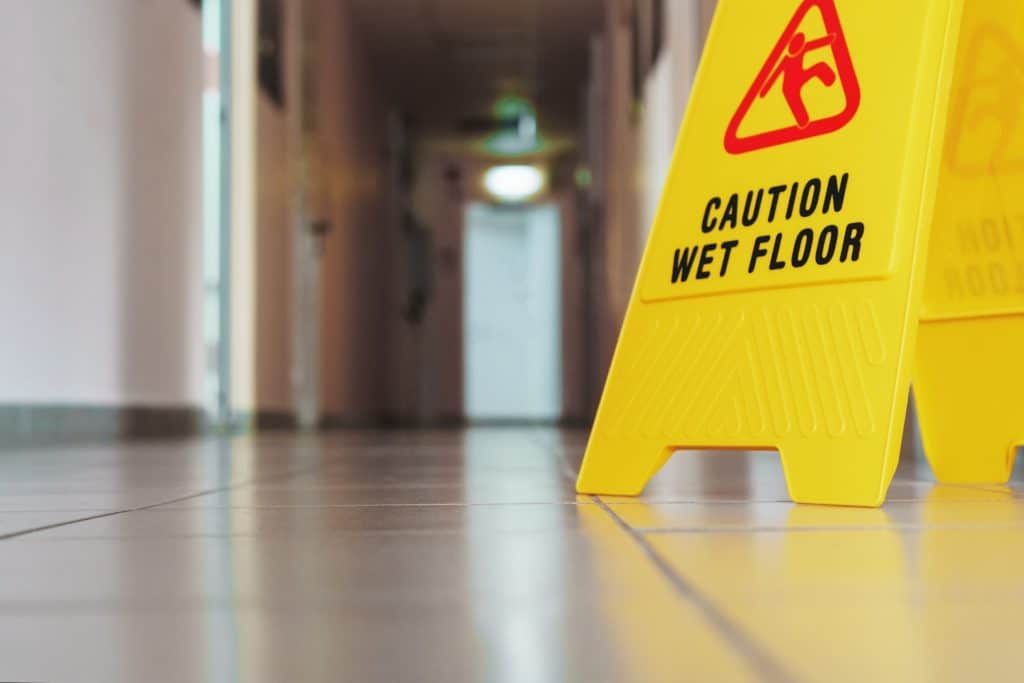Yellow Sign of Wet Floor | Premises Liability Attorney in NYC | Gash & Associates, P.C.