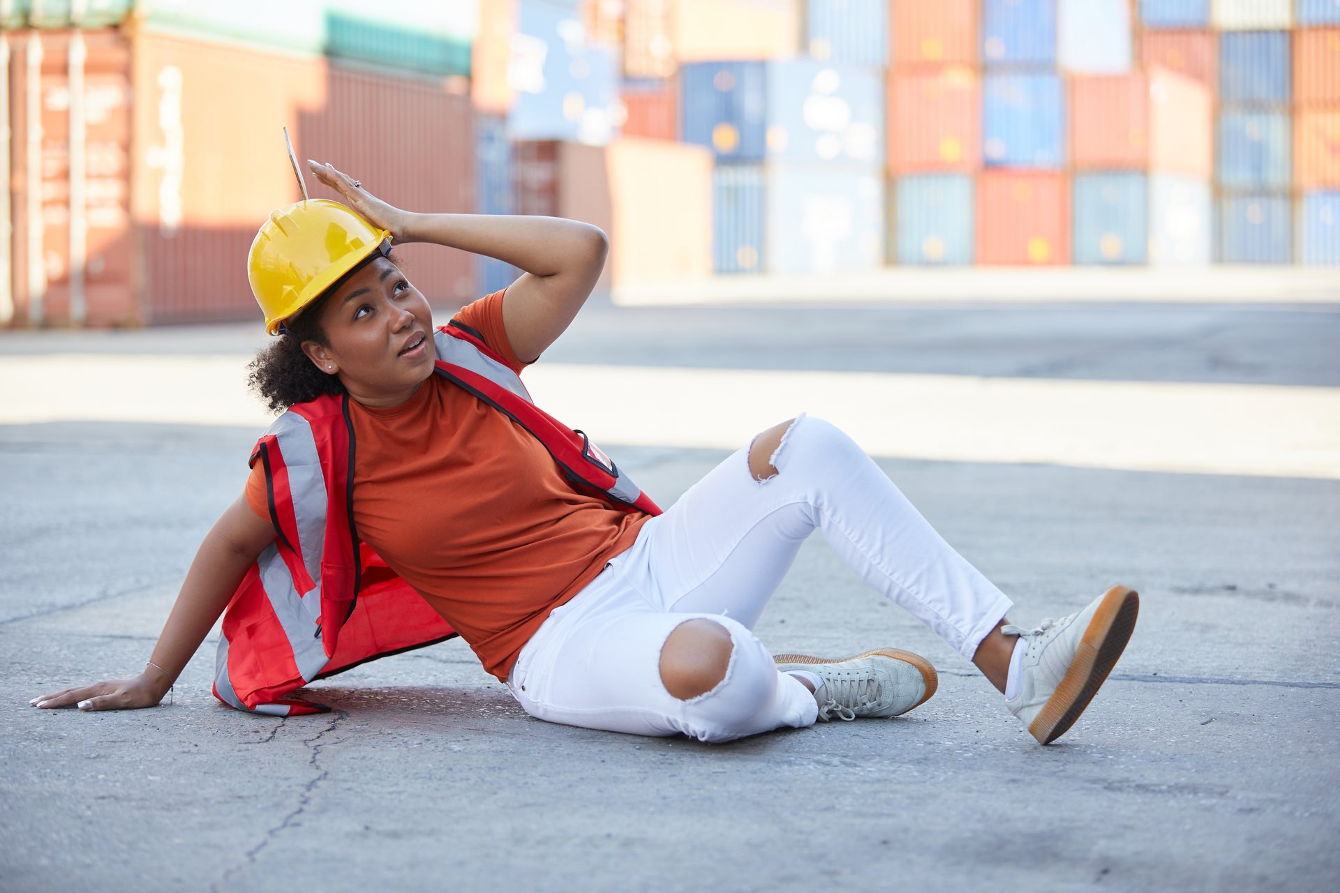 Person wearing a hardhat on the ground