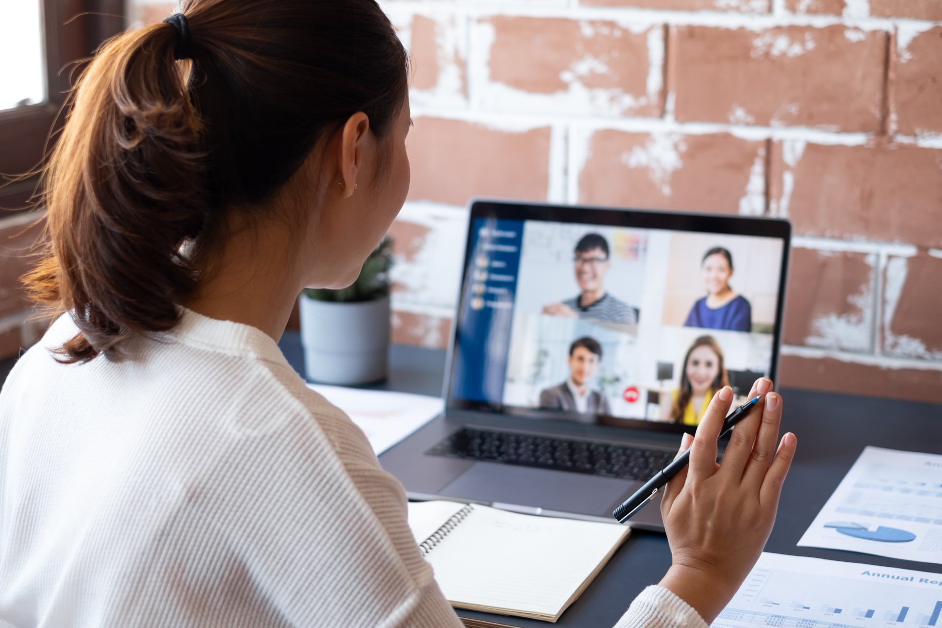 Person sitting at a desk on a call with four other people