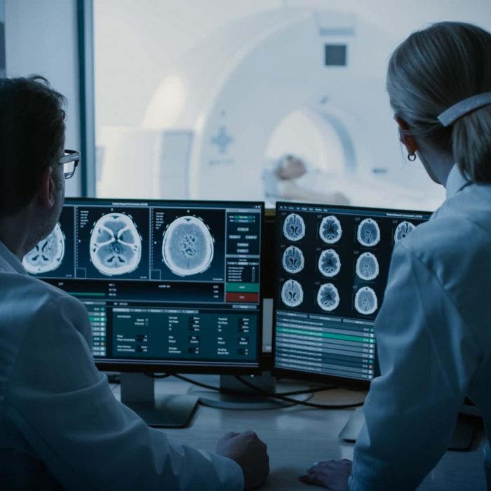 Doctors Monitor Brain Scans Results Doctor and radiologist discuss diagnosis | workplace injury law firm | Gash & Associates, P.C.