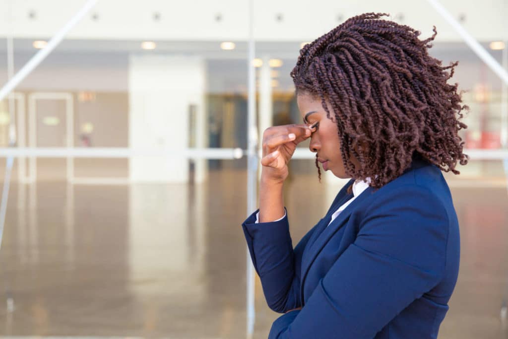 Serious upset female employee thinking over bad news