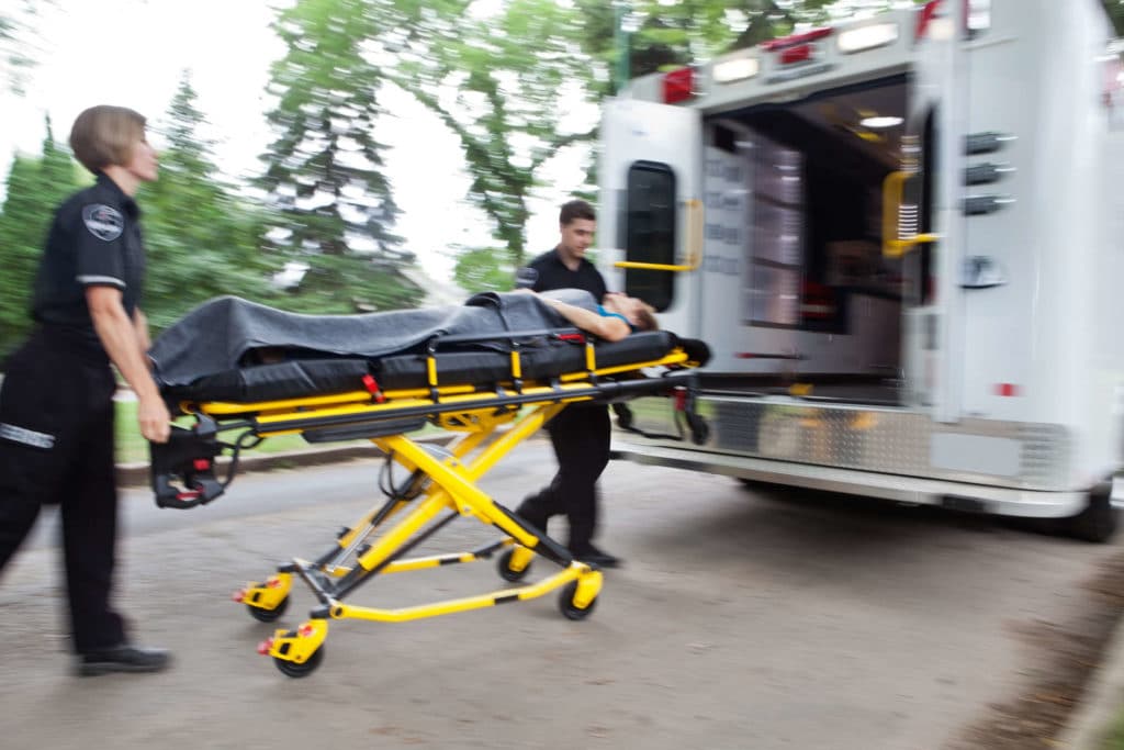 Paramedics Carrying Injured Man To Ambulance | Personal Injury Law Firm | Gash & Associates, P.C.